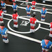 An American Legend foosball table with red and blue figurines of soccer players.