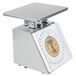 An Edlund stainless steel portion scale with a white dial on a counter.