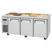 A Turbo Air refrigerated buffet display table with trays of food on a counter.