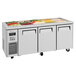 A Turbo Air refrigerated buffet table with three trays of food.