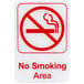 A white rectangular sign with a red circle and text reading "No Smoking" in the middle.