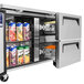 A Turbo Air worktop refrigerator with one door and two drawers open, filled with food.