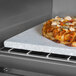 A pizza on a TurboChef baking stone in a Tornado 2 high speed oven.