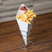 A square cardboard fry cone filled with French fries on a table.
