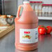 A jug of Firey Louisiana style hot sauce on a counter.