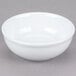 A Tuxton Alaska bright white china nappie bowl on a gray surface.