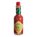 A close up of a TABASCO Cayenne Garlic Pepper hot sauce bottle.