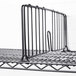 A black Metro wire shelf divider on a wire rack shelf.
