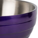 A Vollrath passion purple metal serving bowl with a stainless steel handle.