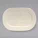 A white oval Tuxton china platter with a small rim.
