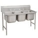 A stainless steel Advance Tabco three compartment sink with two bowls and a drain.