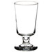 A Libbey footed highball glass with a small rim on top.