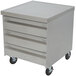 A grey metal Advance Tabco mobile cabinet with 3 drawers on wheels.
