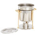 A stainless steel Vollrath chafing dish with brass trim and a lid.