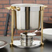 A Vollrath Classic Brass Trim Soup Chafer on a counter.