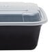A Pactiv Newspring black plastic VERSAtainer square container with a clear lid.