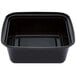 A black Pactiv square microwavable container with a lid.