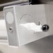 A close up of a Doyon stainless steel dough sheeter with a white button.