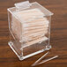 A clear plastic Cal-Mil toothpick dispenser filled with toothpicks on a counter.