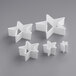 A group of white star shaped cookie cutters.