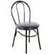 A Lancaster Table & Seating black metal hairpin chair with black vinyl cushion.