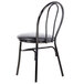 A Lancaster Table & Seating black metal hairpin chair with a black cushion on the seat.