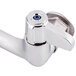 A chrome Equip by T&S wall mounted faucet with 2 blue lever handles.