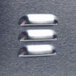 A close up of metal buttons on a metal surface.