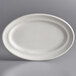 A white Tuxton oval china platter with a curved edge.