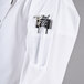 A white Chef Revival ladies' long sleeve coat with black piping on the pocket.
