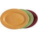 Three Tuxton china oval platters in assorted colors on a white background.
