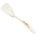 A white spatula with a floral design on it.