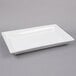 A white rectangular American Metalcraft stoneware platter on a gray surface.