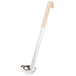 A Vollrath stainless steel ladle with an ivory handle.