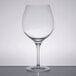 A Stolzle burgundy wine glass on a table.