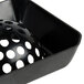 A black plastic dome floor sink strainer with holes in it.