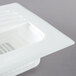 A white plastic FMP floor sink strainer with a square vent.