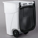 A white Rubbermaid rectangular trash can with black wheels and a black lid.
