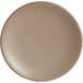 A close-up of a Libbey Driftstone sand satin matte porcelain coupe plate with a white surface.