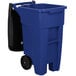 A blue Rubbermaid rectangular trash can with black wheels and a black lid.