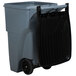 A Rubbermaid grey wheeled rectangular trash can with a black lid.