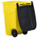 A yellow Rubbermaid commercial trash can with a black lid.