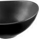 A close-up of a black Libbey Driftstone bowl with a curved edge.