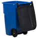 A blue Rubbermaid recycling bin with a black lid.
