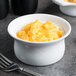 A bowl of macaroni and cheese in a Libbey white porcelain ramekin.