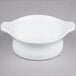 A white Libbey porcelain casserole dish with handles on a gray surface.