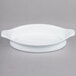 A white oval Libbey Reflections porcelain rarebit dish with handles.