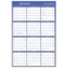 An At-A-Glance blue and white reversible wall planner with blue and white text and numbers.