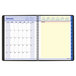 An At-A-Glance spiral bound calendar with a white cover and blue lines on the pages.