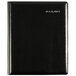 A black leather organizer with silver writing on the cover.